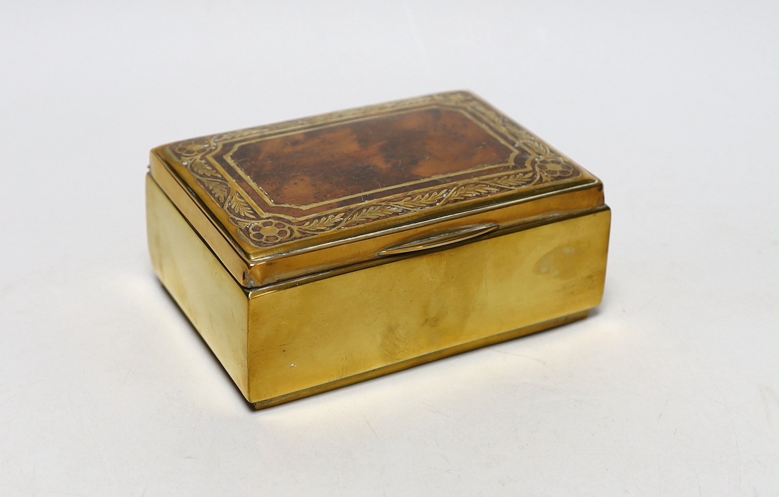 A burr oak topped brasswork cigarette box, 14cm wide, 10cm deep